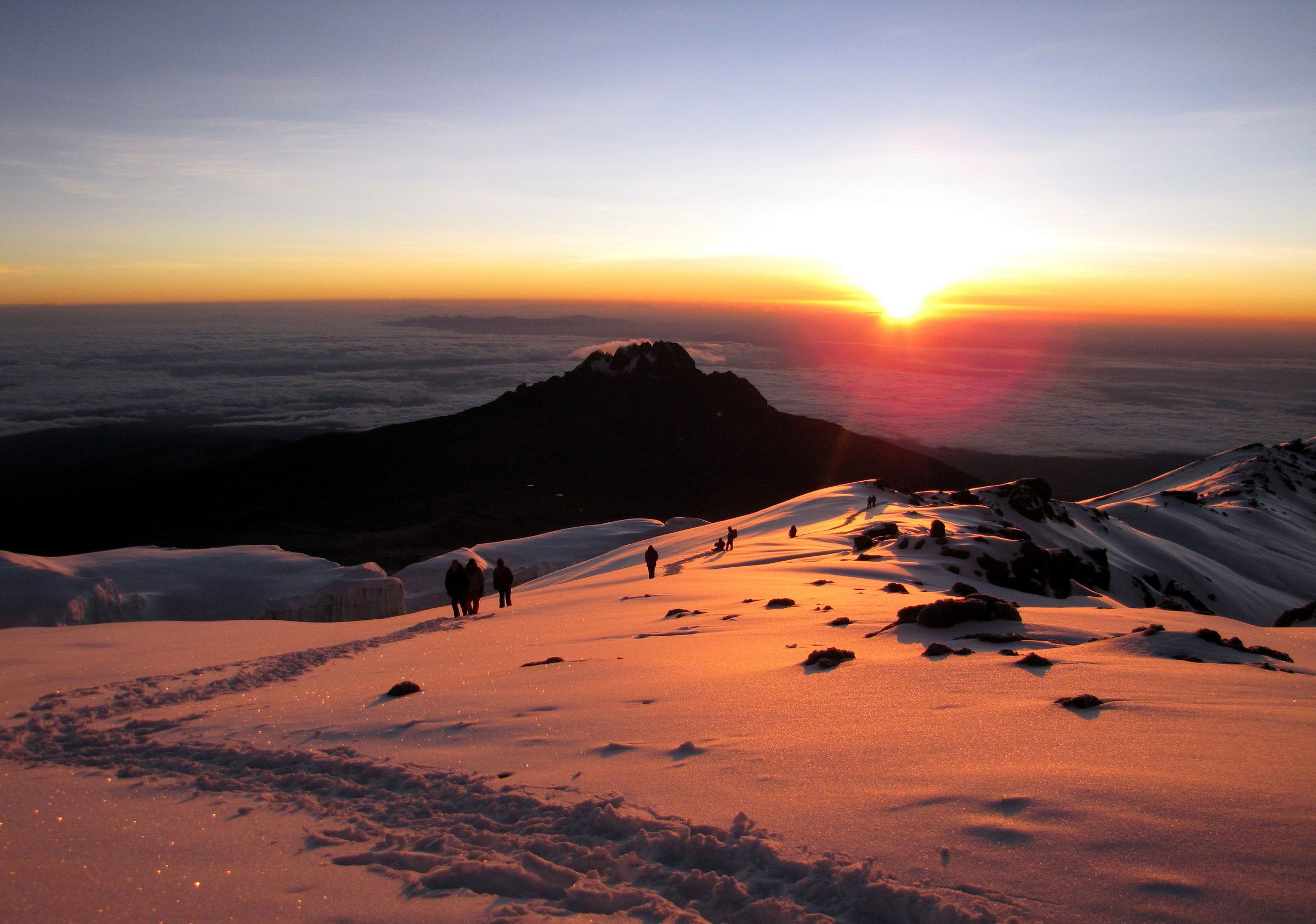 Golden sunrise breaking over a volcanic mountain landscape